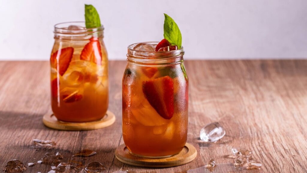 Strawberry lemonade in a glass made with davinci cloudy lemonade and strawberry syrup