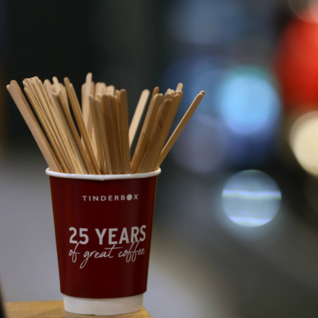 25 years of Tinderbox put on the side of coffee cup