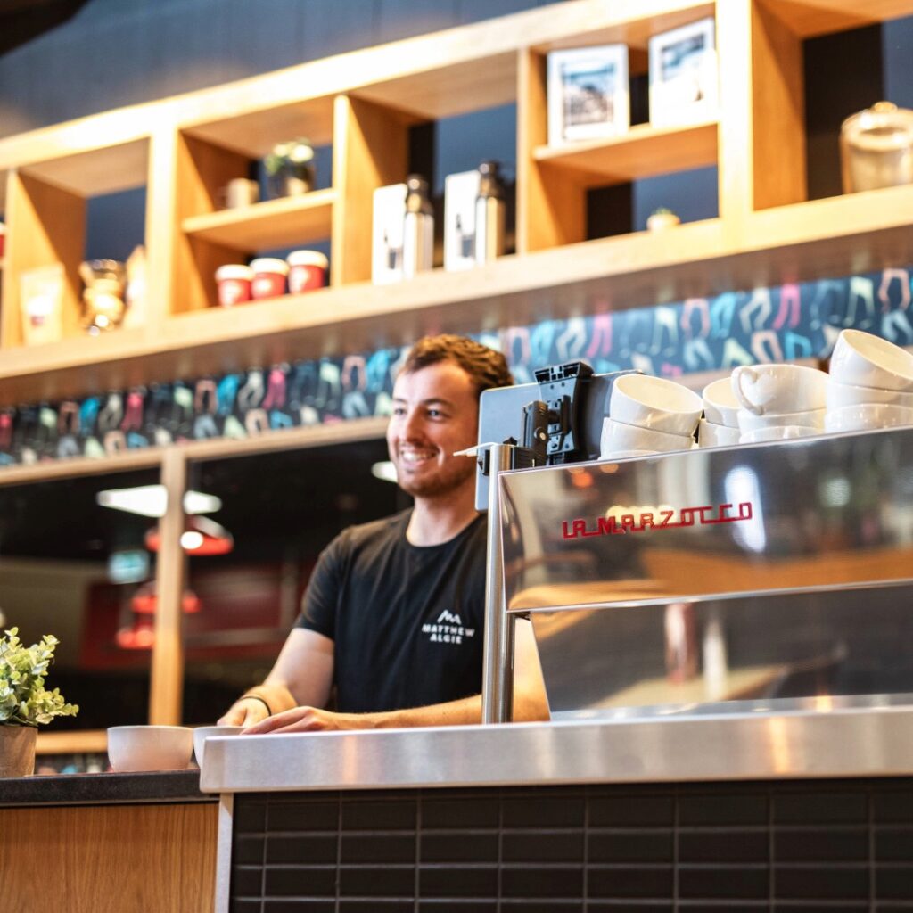 MA staff serving coffee at a customer coffee shop.